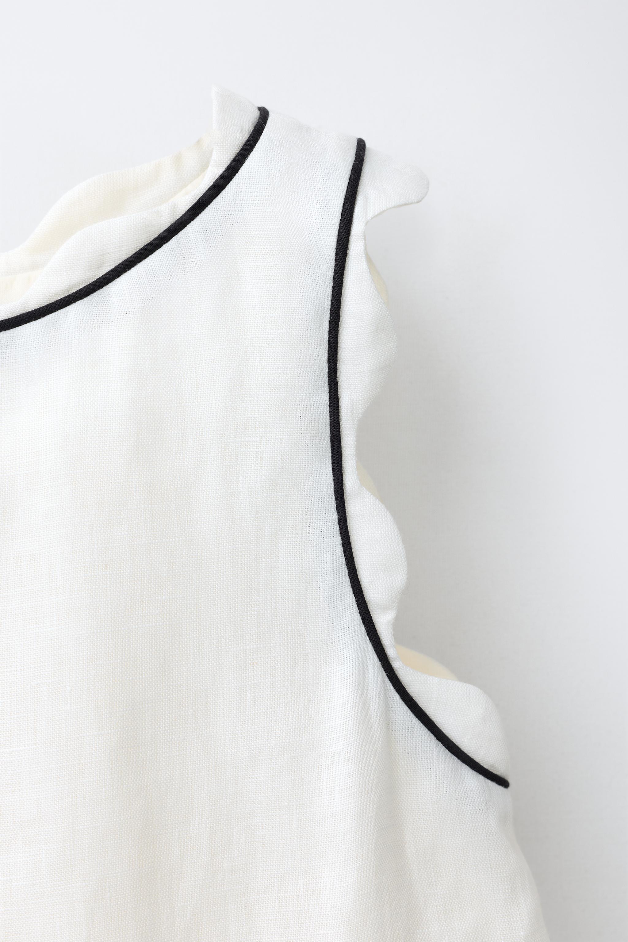 SCALLOPED TOP WITH CONTRAST PIPING